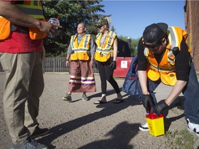 Colin Naytowhow of the Okihtcitawak Patrol Group, a community-based group that walks patrols mainly in the Pleasant Hill area, picks up hazardous materials such as needles and other drug paraphernalia in Saskatoon on June 29, 2019.