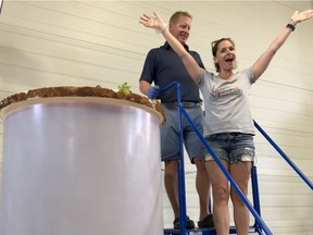 Meredith and Colin Schmidt, co-owners of Last Mountain Distillery, stand beside the tank used to make a 750-litre Caesar, a world-record cocktail. The Caesar was made as part of their 5th annual Caesar Fest, which took place on July 6, 2019. (submitted photo from Meredith Schmidt)