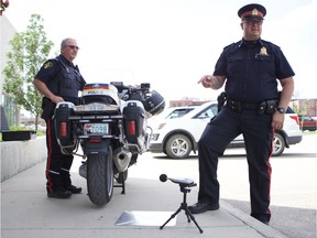 Staff Sgt. Patrick Barbar (right) and Sgt. Dean Hoover (left) demonstrate the device used to measure noise from motorcycles in the parking lot of Saskatoon Police Service head office in Saskatoon on July 9, 2019.