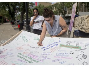 SASKATOON,SK--JULY 10/2019-*0711 news sex ed - Savannah Holt draws on a banner at a rally outside of the premiers' meeting by Action Canada for Sexual Health and Rights in Saskatoon, SK on Wednesday, July 10, 2019.