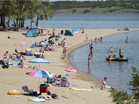 Beach-goers enjoy nice weather at Regina Beach Thursday. The popular recreation area is one of 67 public swimming areas in the province that will have its water quality testing results posted online.