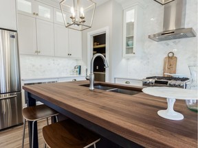 A stunning black walnut butcher-block countertop, custom crafted in Edmonton, graces the navy blue island in Delonix Homes' show home, located at 302 Boykowich Street in Evergreen. (Supplied photo)