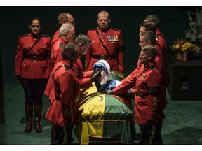 Members of the Royal Canadian Mounted Police lay a star blanket on the casket at the funeral for the Honourable W. Thomas Molloy, Saskatchewan's 22nd Lieutenant Governor in Saskatoon, SK on Saturday, July 13, 2019.