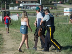 RCMP officers detain a man during the Country Thunder music festival.