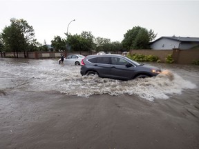 The intersection of Woodhams Drive and Woodland Grove Drive flooded after heavy rains in Regina. TROY FLEECE / Regina Leader-Post