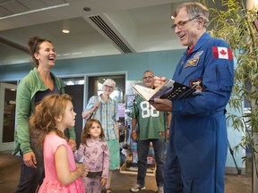 Six-year-old Adelle Wheeler speaks with Canadian astronaut Dave Williams at the Imax Theatre in Regina.