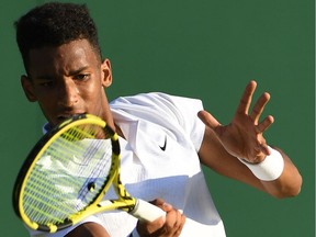 Canada's Felix Auger-Aliassime returns the ball to France's Corentin Moutet during their men's singles second round match on the third day of the 2019 Wimbledon Championships at The All England Lawn Tennis Club in Wimbledon, southwest London, on July 3, 2019.