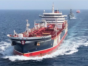 A handout picture taken on and released by the Ministry of Defence on July 25, 2019 shows the HMS Montrose (C) accompanying the Stena Important (L) and the Sea Ploeg vessels in the Gulf.