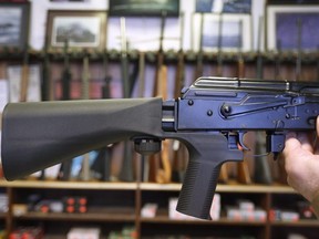 A bump stock device (left) that fits on a semi-automatic rifle to increase the firing speed, making it similar to a fully automatic rifle, is installed on a AK-47 semi-automatic rifle, (right) at a gun store in Salt Lake City, Utah on Oct. 5, 2017.
