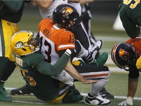 The B.C. Lions have had all sorts of problems protecting quarterback Mike Reilly, 13, who is shown being sacked by the Edmonton Eskimos' Nick Usher on June 21.