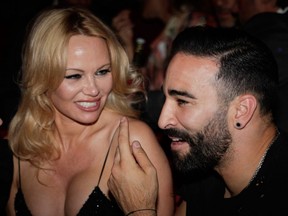 Pamela Anderson (left) and Marseille's French defender Adil Rami (right) attend the premiere of the new show "Bionic ShowGirl" at the "Crazy Horse" cabaret in Paris on June 3, 2019.