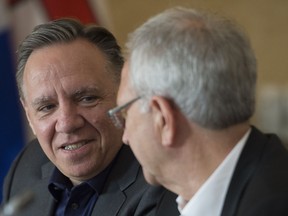 Quebec Premier Francois Legault speaks with New Brunswick Premier Blaine Higgs during a meeting of Canada's Premiers in Saskatoon, Sask.Wednesday, July 10, 2019.