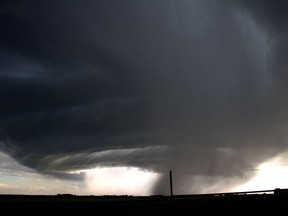 Alberta storm chaser Chris Kiernan has hardly had a moment's rest since the start of the tornado season last month. A supercell is seen over an area east of Calgary in a July 13, 2019, handout photo. As of Monday afternoon, there have been 17 tornadoes in the province according to Environment and Climate Change Canada.