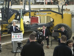 Federal infrastructure minister François-Philippe Champagne, left, after he and Saskatchewan Deputy Premier Gord Wyant, centre, signed an infrastructure deal worth almost $1 billion over 10 years.