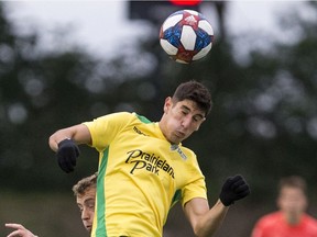 Nikolas Baikos with the SK Selects all-star squad heads the ball away from the Vancouver Whitecaps U-23 team during a SK Summer Series friendly soccer match in Saskatoon on Thursday, July 25, 2019.