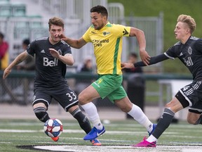 Captain Jordian Farahani with the Saskatchewan Selects all-star squad moves the ball away from the Vancouver Whitecaps U-23 team during a SK Summer Series friendly soccer match in Saskatoon, SK on Thursday, July 25, 2019.