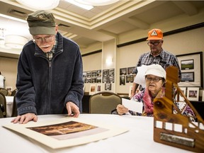 SASKATOON,SK--August 2/2019-*0803 news Uranium City - Former Uranium City resident Bob Aaberg, left, looks at a photo of the the mine head frame he helped design.  Aaberg joined other former residents at a reunion hosted by the Uranium City Reunion Committee in Saskatoon, SK on Friday, August 2, 2019.