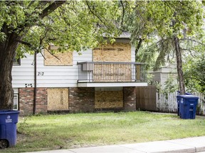 Plywood covers windows on a house on Avenue V in Pleasant Hill in Saskatoon, SK on Thursday, August 8, 2019.