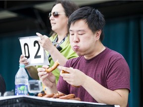 Ken Kwan devours a spudnut in an eating contest at the Saskatoon Ex. Contestants attempted to eat 12 spudnuts in 5 minutes in Saskatoon, SK on Friday, August 9, 2019.
