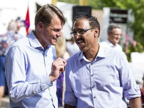 Saskatoon Mayor Charlie Clark, left, speaks with federal Natural Resources Minister Amarjeet Sohi at a funding announcement for Shakespeare On The Saskatchewan.