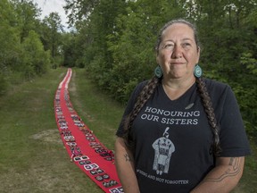 Organizer Christi Belcourt stands with the final installation of Walking With Our Sisters, an art installation made up of more than 2,000 moccasin vamps (tops) honouring missing and murdered Indigenous women, girls and others in Batoche, Sask. on Thursday, August 15, 2019. (Saskatoon StarPhoenix/Liam Richards)