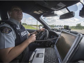 RCMP Crime Reduction Team Corporal Tyler Zrymiak in his patrol vehicle in Onion Lake First Nations on Wednesday, July 17, 2019.