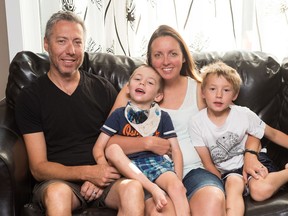 From left, Mike Stumph, Theo Stumph, Heather Leask and Nathan Stumph sit on a sofa in their Regina home. BRANDON HARDER/ Regina Leader-Post