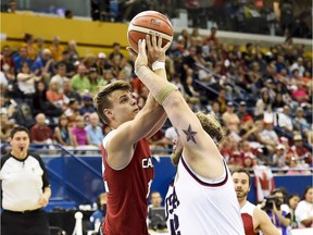 Canada's Nik Goncin, left, shown at the 2015 Parapan American Games in Toronto, has helped Canada's men's wheelchair basketball team qualify for the 2020 Paralympics in Tokyo.