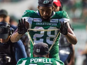 Saskatchewan Roughriders defensive back Loucheiz Purifoy, 28, drapes the team's new Big Play Chain around the neck of William Powell following a touchdown in Saturday's 40-18 victory over the visiting Ottawa Redblacks.