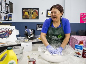 Maryann Napope, a board member from the Saskatoon Indian Metis Friendship Centre, mixes dough for bannock at the Indian/Metis pavilion at Folkfest in Saskatoon on Friday, August 16, 2019.