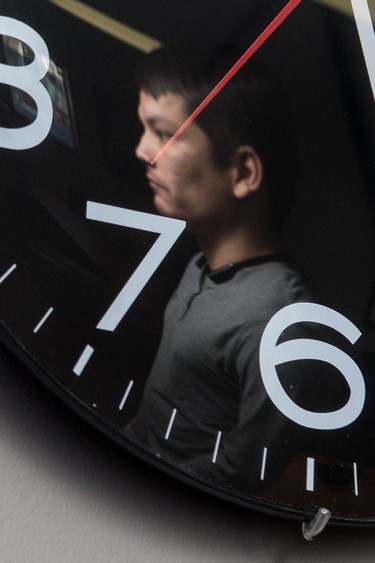 Cody Lee Francis can be seen in the reflection of a clock at the John Howard Society office on Toronto Street. Francis, who served time in jail and dealt with an addiction inside, is now assisting in programs that help youth who have addiction struggles. BRANDON HARDER/ Regina Leader-Post