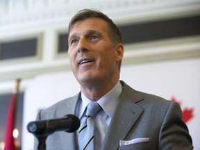 People's Party of Canada Leader Maxime Bernier speaks from a podium at an announcement in Toronto on June 21, 2019.