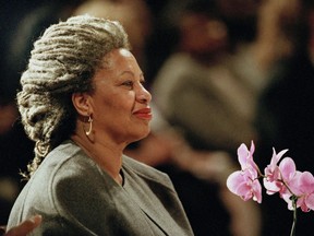 FILE - In this April 5, 1994 file photo, Toni Morrison as she holds an orchid at the Cathedral of St. John the Divine in New York.   The Nobel Prize-winning author has died. Publisher Alfred A. Knopf says Morrison died Monday, Aug. 5, 2019 at Montefiore Medical Center in New York. She was 88.