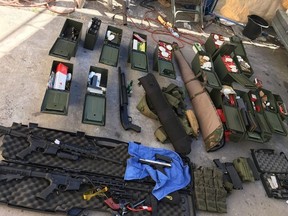 This handout photo released on Thursday, Aug. 22, 2019 courtesy of Long Beach Police Department shows multiple firearms, hundreds of rounds of ammunition and tactical gear seized from suspect Rodolfo Montoya of Huntington Beach, Calif.