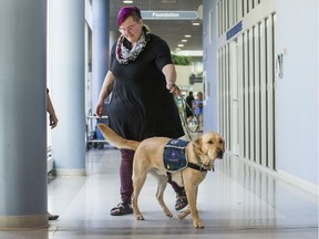 Facility dog Quinn and Assistant Coordinator and facility dog handler Jillian Doucet during a media event at Saskatoon City Hospital in Saskatoon, Sask. on Tuesday, September 3, 2019. The Saskatchewan Health Authority and Gateway Regional Victim Services announced a partnership for the provision of a Facility Dog to support individuals affected by significant trauma and other victims of violence and crime.