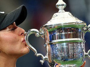 Bianca Andreescu of Canada kisses the championship trophy during the trophy presentation ceremony after winning the Women's Singles final against Serena Williams of the United States on day thirteen of the 2019 US Open at the USTA Billie Jean King National Tennis Center on September 07, 2019 in Queens borough of New York City.