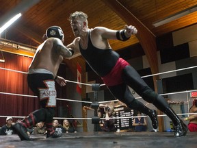 Jay Janzen, known as Dice Steele when wrestling, right, clotheslines El Asesino during the 6 man rumble main event of the High Impact Wrestling "Christmas Rampage" at the Seniors Centre on Saturday, December 5th, 2015.