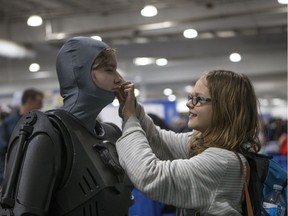 Kenzie Phillip gets her costume fixed by Sandra Phillip during the Saskatchewan Entertainment Expo at Prairieland Park in Saskatoon, Sept. 15, 2018.