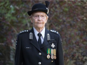 Mary Walters, who has been a volunteer with St. John Ambulance for 53 years, stands in her uniform in the backyard at her home in Pilot Butte.