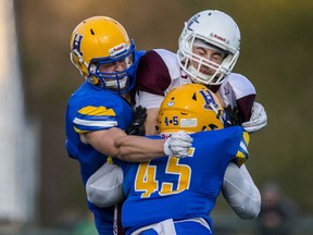 Saskatoon Hilltops linebacker Jadyn Pingue and defensive back Brady Fossen hit Regina Thunder quarterback Blake Scherle in CJFL action at SMF Field in Saskatoon, SK on Saturday, September 7, 2019.