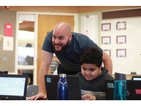 French immersion teacher Eric Martin works with student Mohammad Khan at Dundonald School on Sept. 19, 2019.