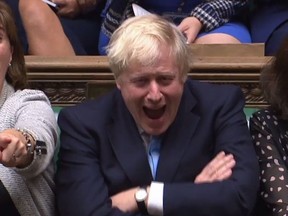 A video grab from footage broadcast by the UK Parliament's Parliamentary Recording Unit (PRU) shows Britain's Prime Minister Boris Johnson (R) and Britain's Culture Secretary Nicky Morgan (L) reacting as Britain's main opposition Labour Party Jeremy Corbyn speaks in response to his speech to introduce a motion for an early parliamentary general election in the House of Commons in London on September 9, 201.