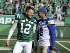 Winnipeg Blue Bombers kicker Justin Medlock, left, congratulates the Saskatchewan Roughriders' Brett Lauther on his game-winning field goal Sunday at Mosaic Stadium.