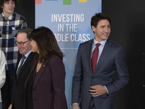 Prime Minister Justin Trudeau, right, arrives for a speech to students at Alma College, Thursday, April 4, 2019 in Alma Que. Lac St-Jean MP Richard Hebert, left, leads the way. The official campaign may be in its infancy, but over the summer Liberal politicians were already hard at work, roaming the country and making hundreds of spending announcements in Canadian ridings.