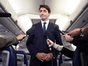 Liberal Leader Justin Trudeau speaks on his campaign plane regarding a 2001 photo that surfaced of him wearing brownface, Sept. 18, 2019.