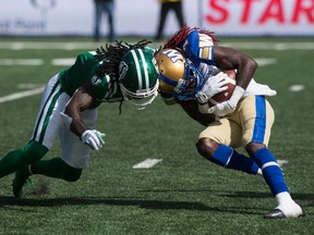 Winnipeg Blue Bombers receiver Lucky Whitehead, left, collides with Saskatchewan Roughriders defensive back Ed Gainey during Sunday's Labour Day Classic at Mosaic Stadium. The teams are to meet again Saturday in Winnipeg.
