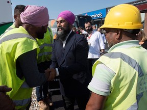 NDP Leader Jagmeet Singh speaks with construction workers who stopped doing road work to listen to his speech during a campaign announcement in Essex, Ont., Friday Sept. 20, 2019.