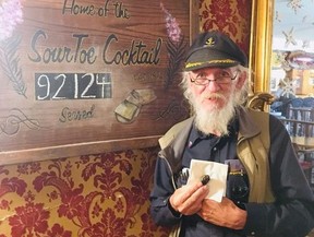 Downtown Hotel sourtoe "toe master" Terry Lee holds the newly mummified big toe of Nick Griffiths in a handout photo. Former British Marine Griffiths is set to become the most exclusive member of an already exclusive club when he visits the Downtown Hotel in Dawson City to sip a so-called sourtoe cocktail; a shot of whisky with a mummified human toe in it. THE CANADIAN PRESS/HO-Downtown Hotel, Dawson City, Yukon MANDATORY CREDIT