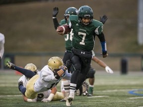 Holy Cross Crusaders quarterback Tilawa Mudasia breaks a tackle against the Bethlehem Stars during the city high-school football 6A semifinal in Saskatoon, SK on Wednesday, October 23, 2019.