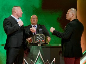 WWE champion Brock Lesnar and former UFC heavyweight champion Cain Velasquez face off as Lesnar's advocate Paul Heyman looks on during the announcement of their match at a WWE news conference at T-Mobile Arena on October 11, 2019 in Las Vegas, Nevada. Lesnar will face Velasquez and WWE wrestler Braun Strowman will take on heavyweight boxer Tyson Fury at the WWE's Crown Jewel event at Fahd International Stadium in Riyadh, Saudi Arabia on October 31.